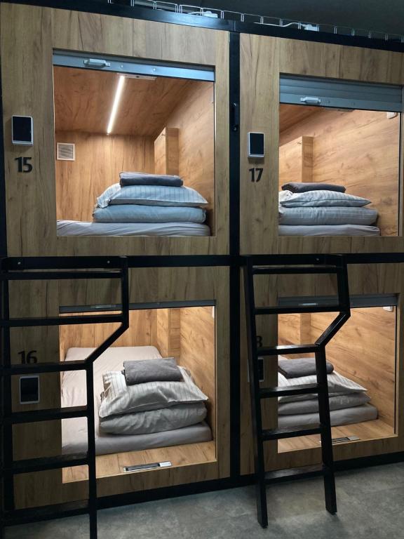 A narrow corridor with stacked sleeping compartments on both sides.